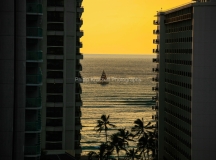 Water off Waikiki coast through hotel buildings in Evening.